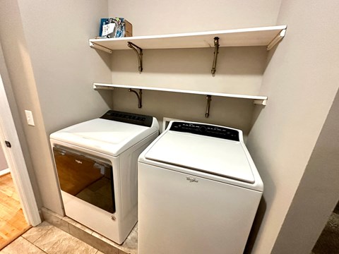 Two white ovens are in a small kitchen.
