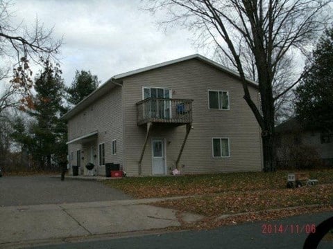 a house with a balcony on the side of a street
