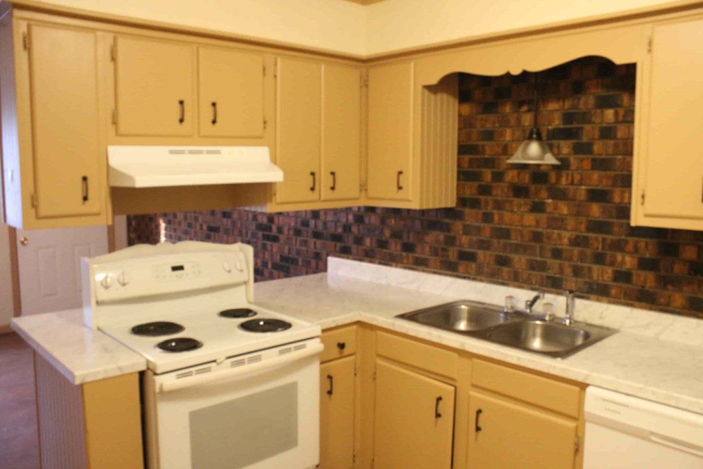a kitchen with a stove and a sink