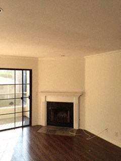a living room with white walls and a fireplace