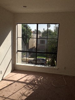 an empty living room with a large window