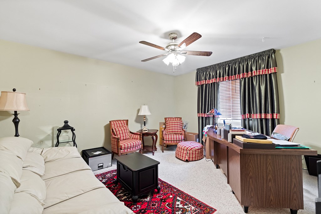 a living room with a couch and a ceiling fan