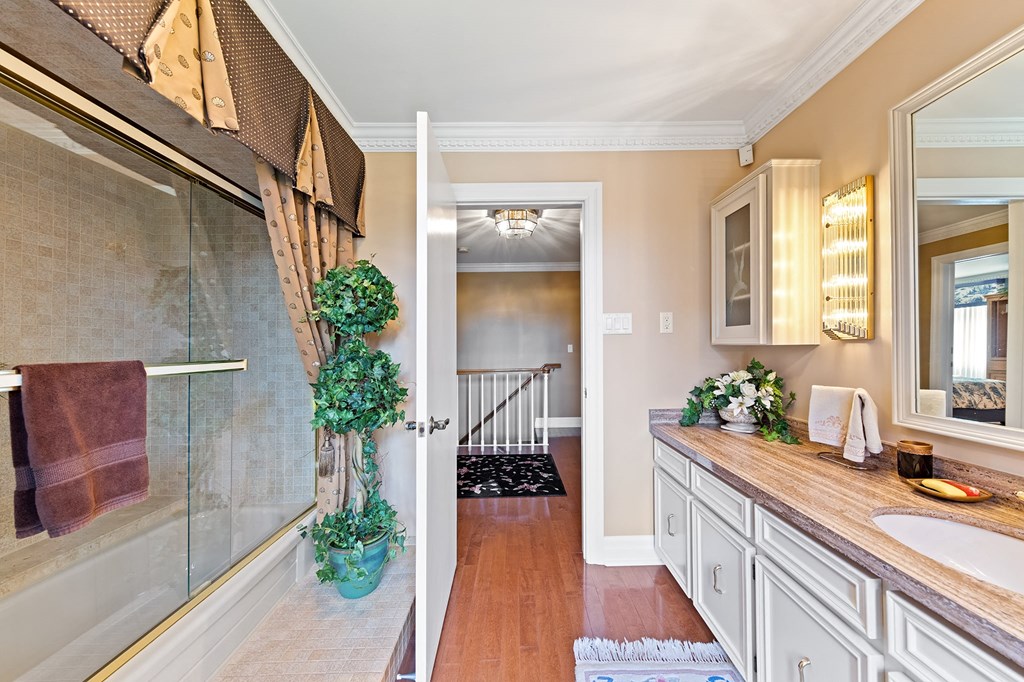 a bathroom with a sink and a glass shower