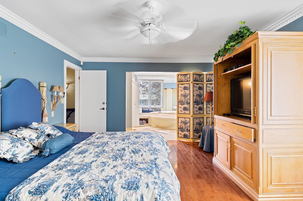 a bedroom with a bed and a television