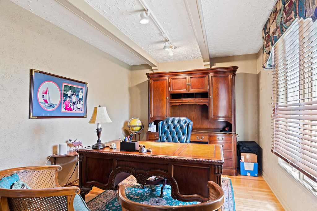 a home office with a desk and a chair and a cabinet
