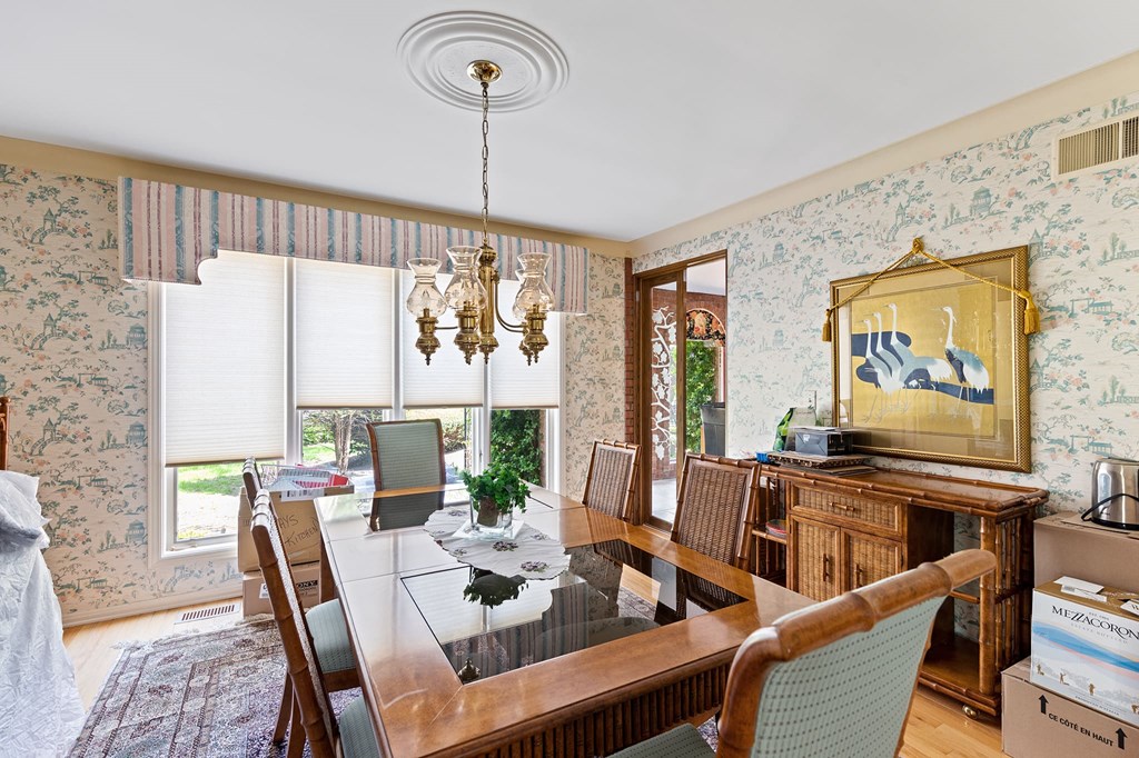 a dining room with a wooden table and chairs