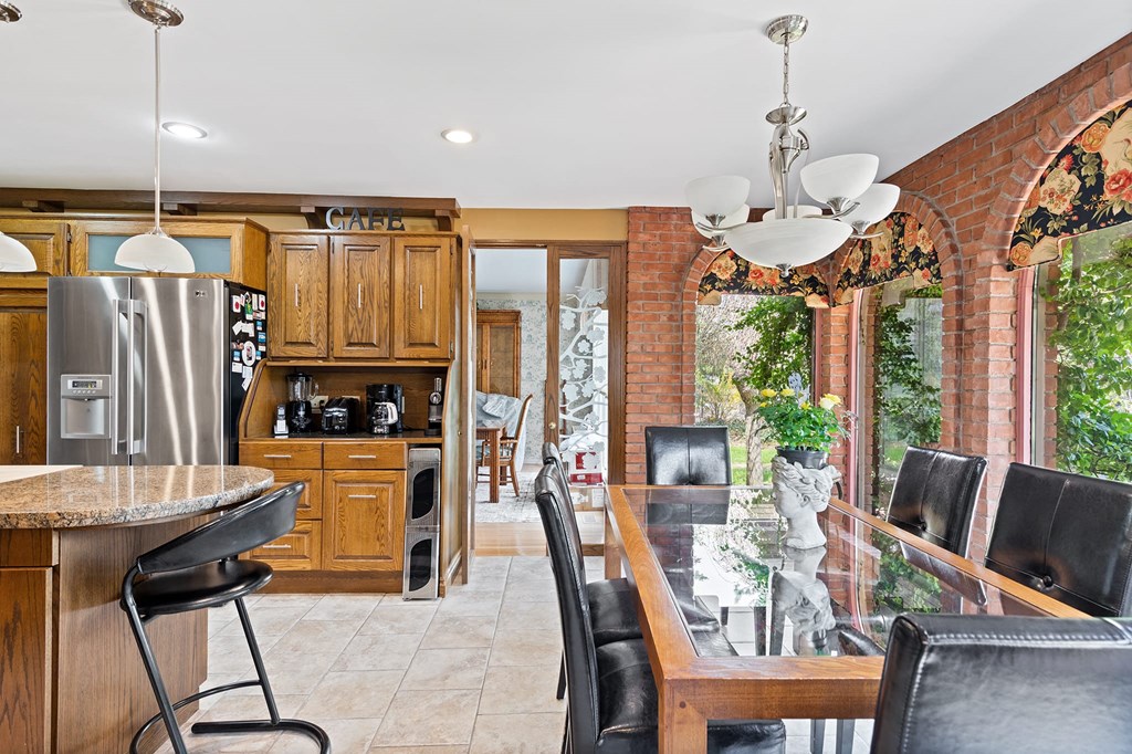 a kitchen with a bar and a table with chairs