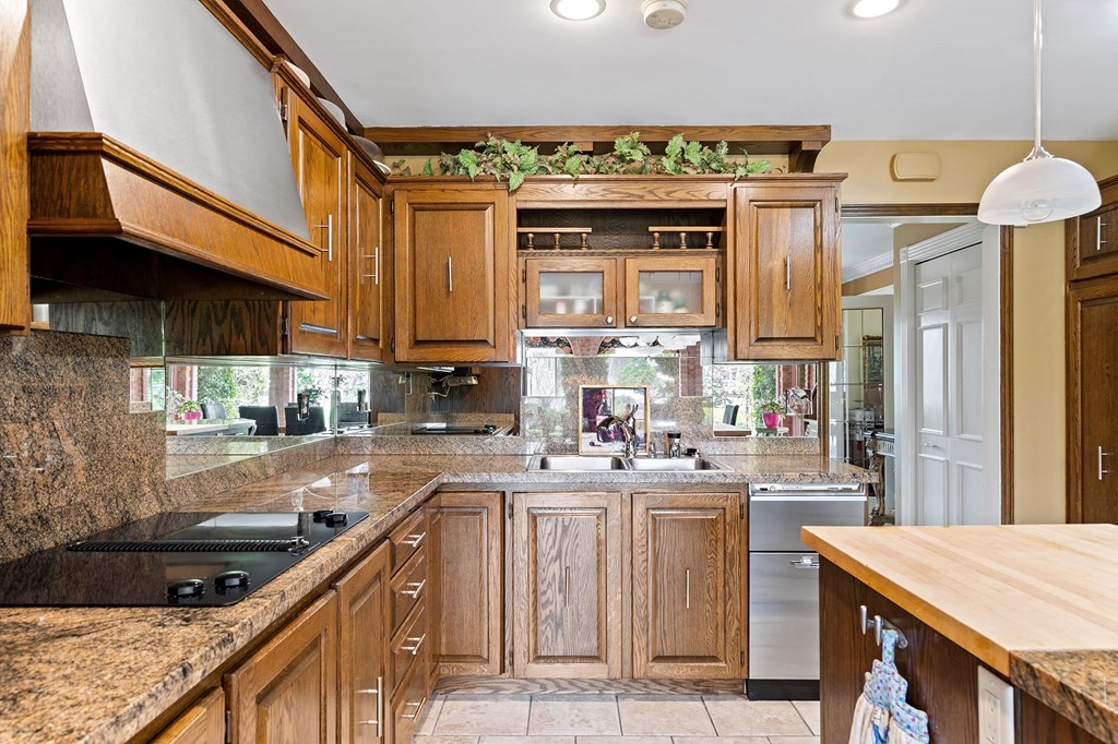 a kitchen with wooden cabinets and granite counter tops