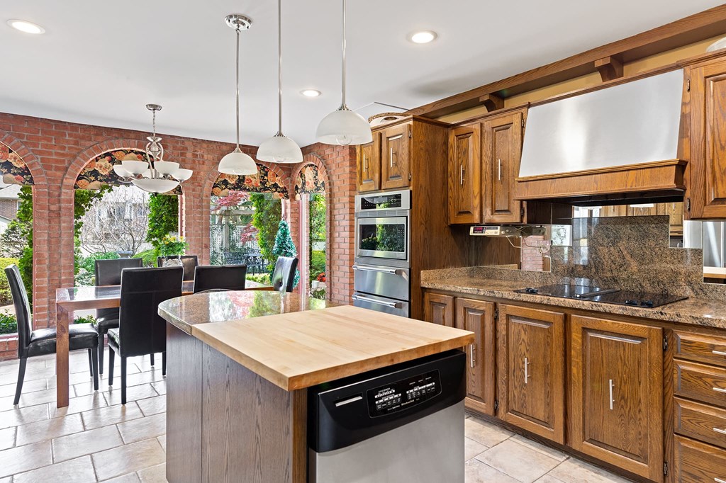 a large kitchen with wooden cabinets and a large island