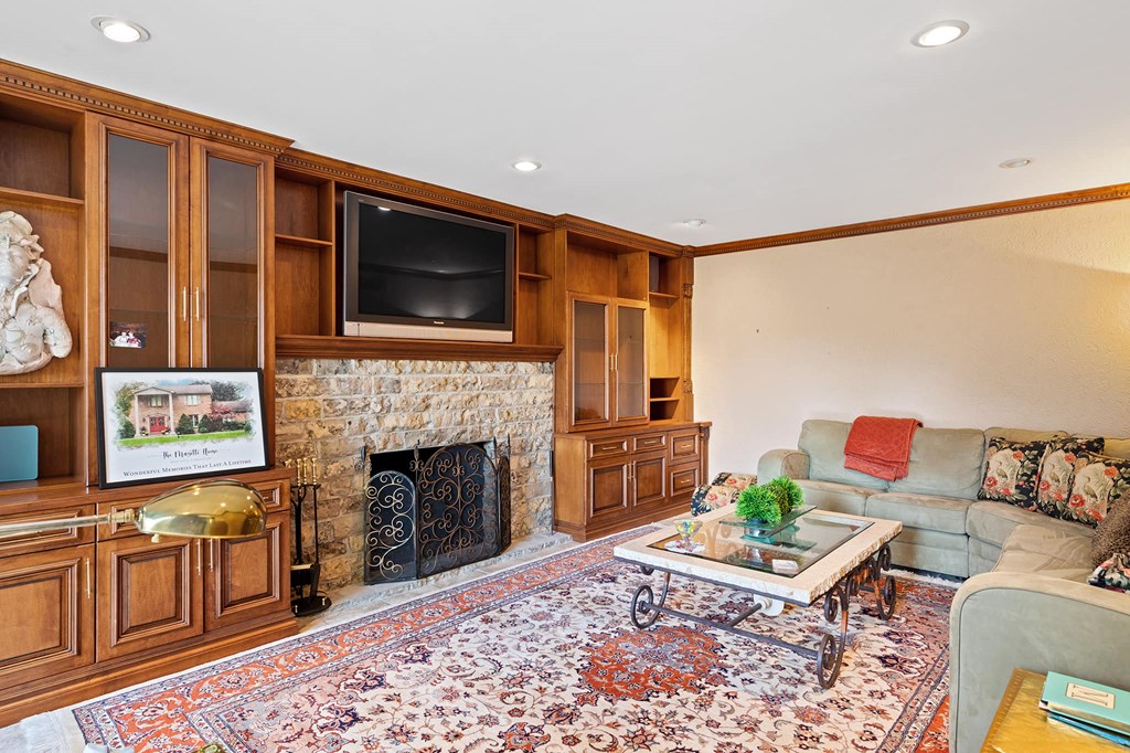 a living room with a fireplace and a television