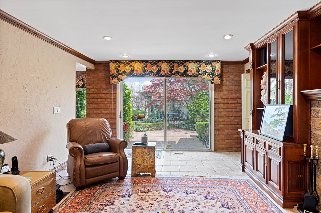 a living room with a chair and a door to a backyard