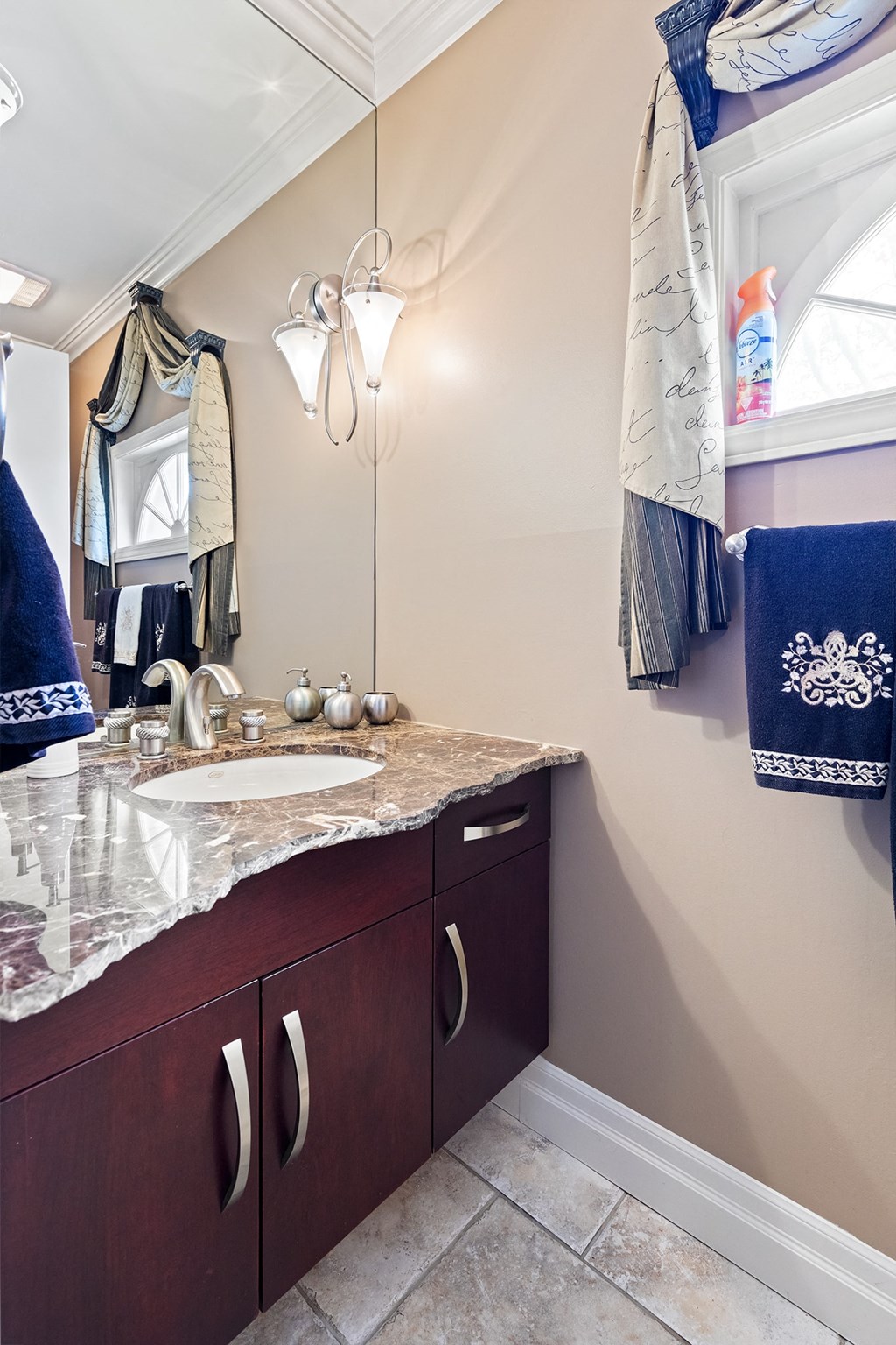 a bathroom with a marble counter top and a sink