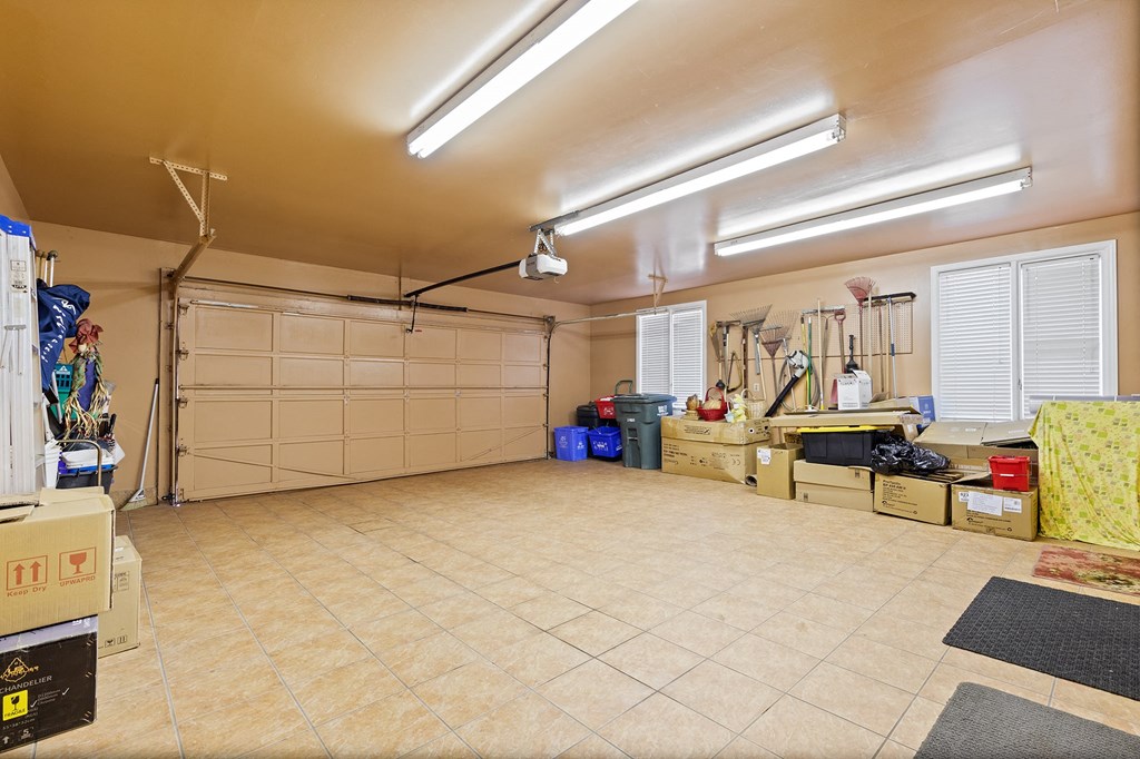 a garage with a tile floor and a white garage door