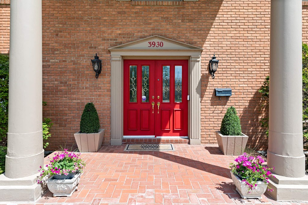 a red door on the side of a brick building