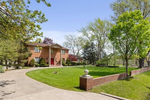 the front of a house with a yard and a driveway