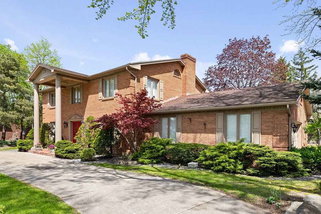 a brick house with a driveway in front of it