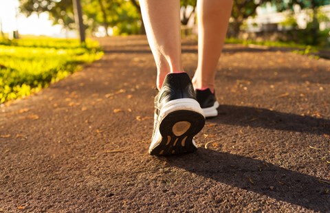 a person walking down a path with their shoes on