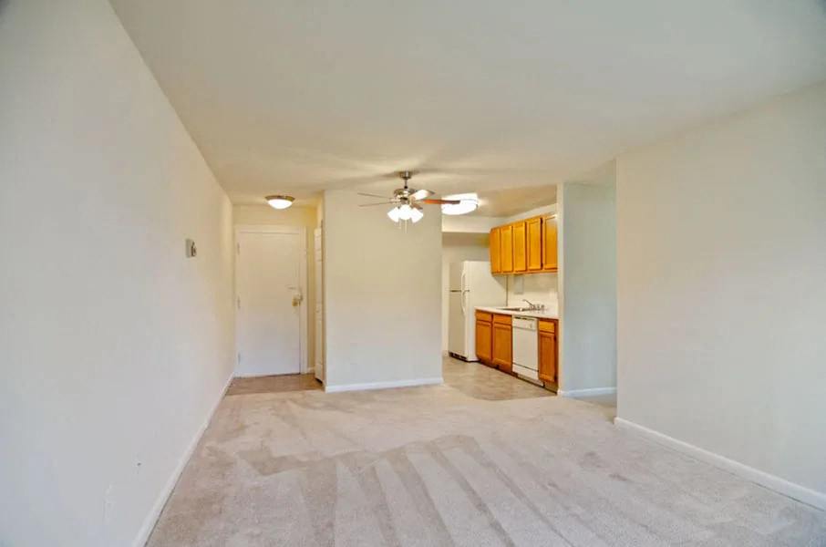 View of living area, kitchen, and entrance at Broadfalls in Falls Church, VA