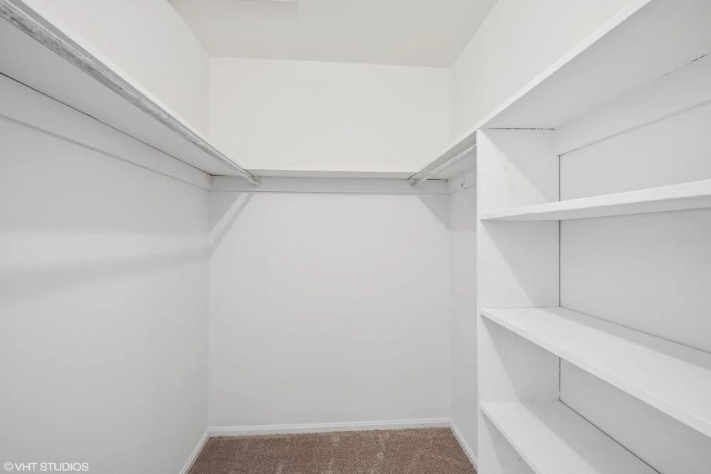 Large walk in closet with tons of storage