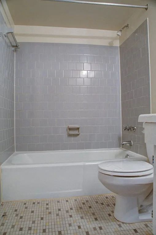 Tiled floor bathroom with subway tiled shower