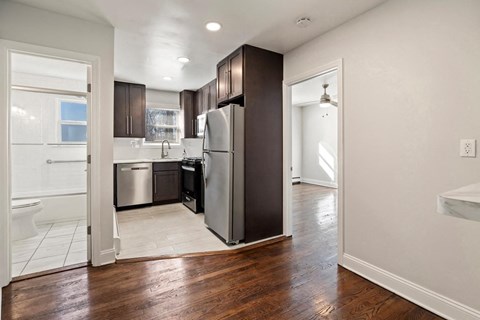 a renovated kitchen with a stainless steel refrigerator