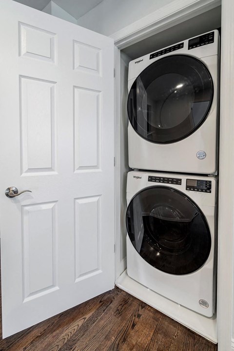 a white washer and dryer in a small closet