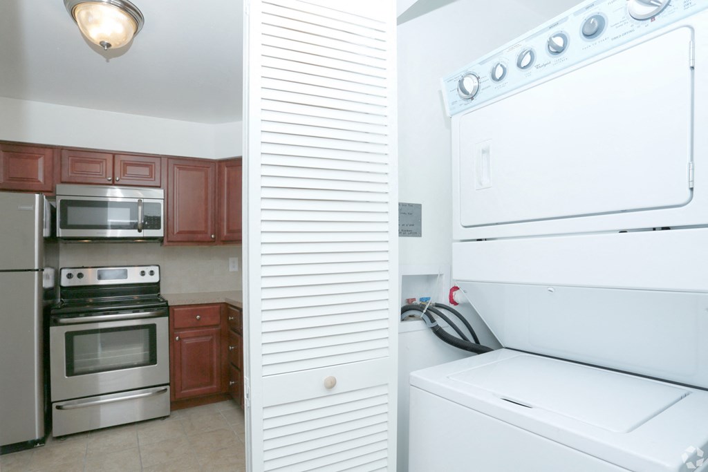 a kitchen with white appliances and a stove and a refrigerator