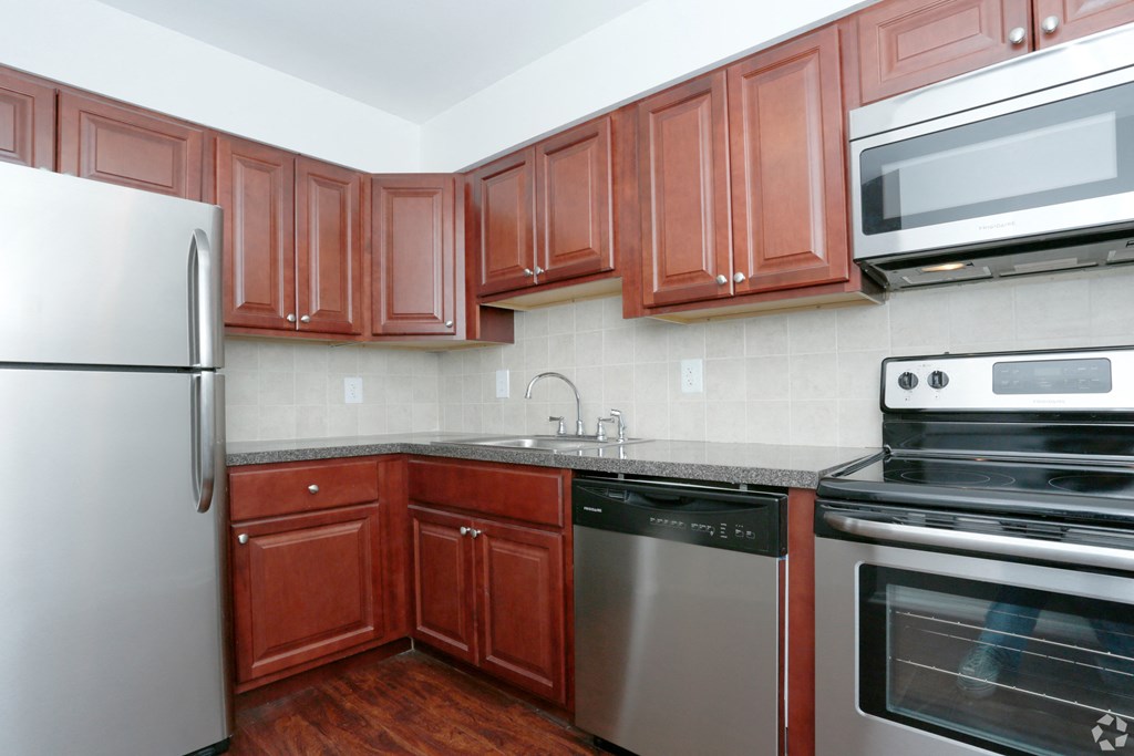 a kitchen with stainless steel appliances and wooden cabinets