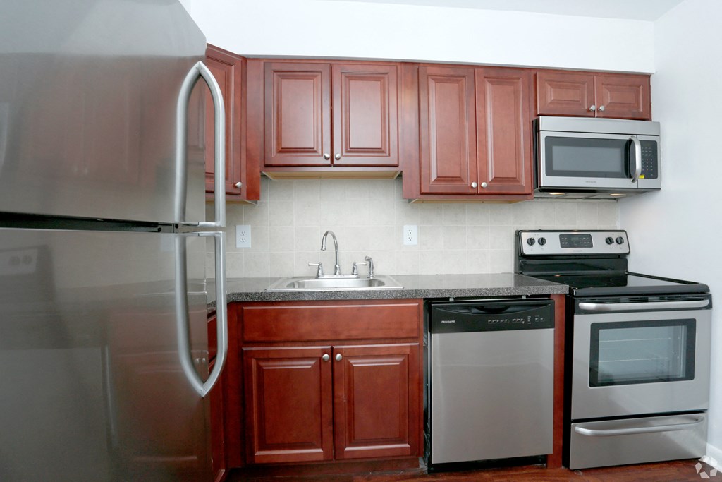 a kitchen with stainless steel appliances and wooden cabinets