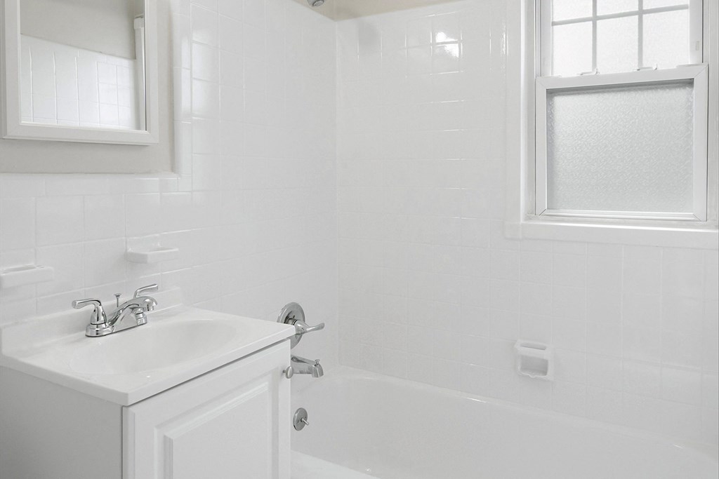 a small bathroom with a sink and a bath tub