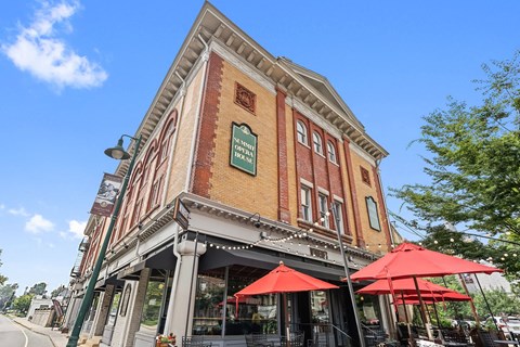 A building with a red awning and a sign that says "The Old Mill".