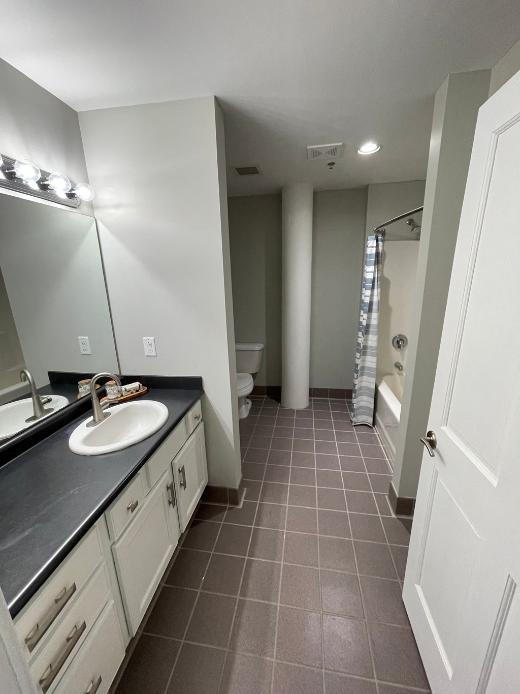 a bathroom with a sink and a toilet and a shower