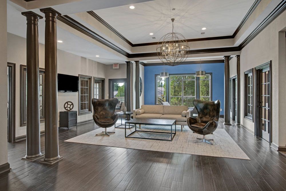 a living room with furniture and a chandelier