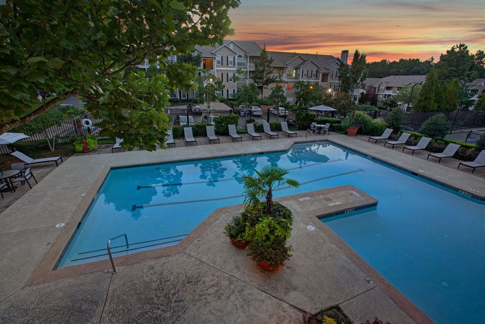 an aerial view of a swimming pool at sunset