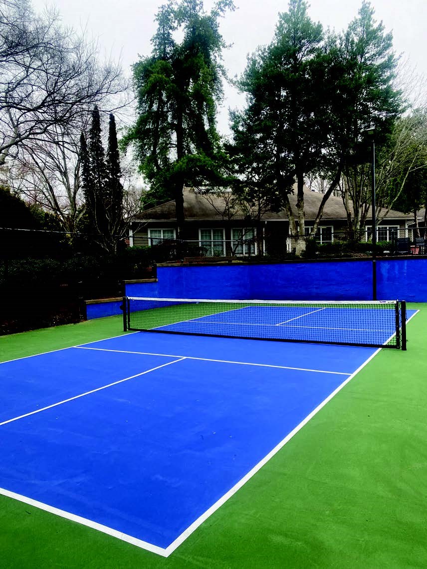 a blue and green tennis court with a net