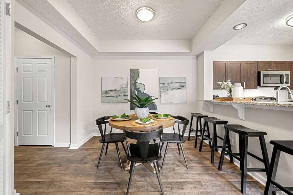 an open kitchen and dining area with a table and chairs