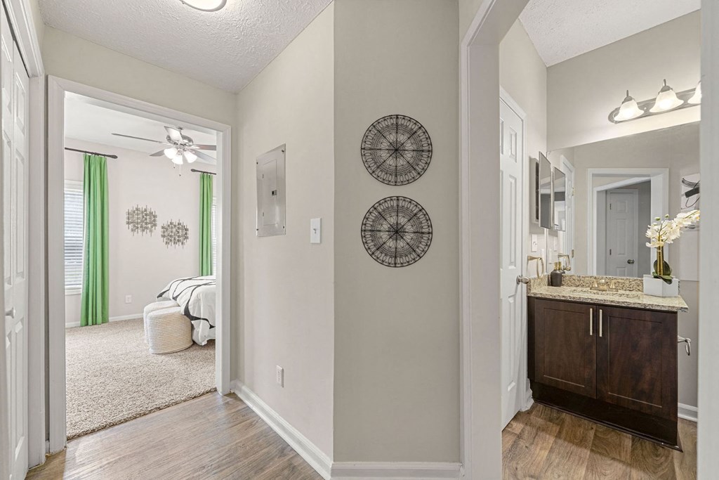 an open kitchen and living room with a door to a bedroom