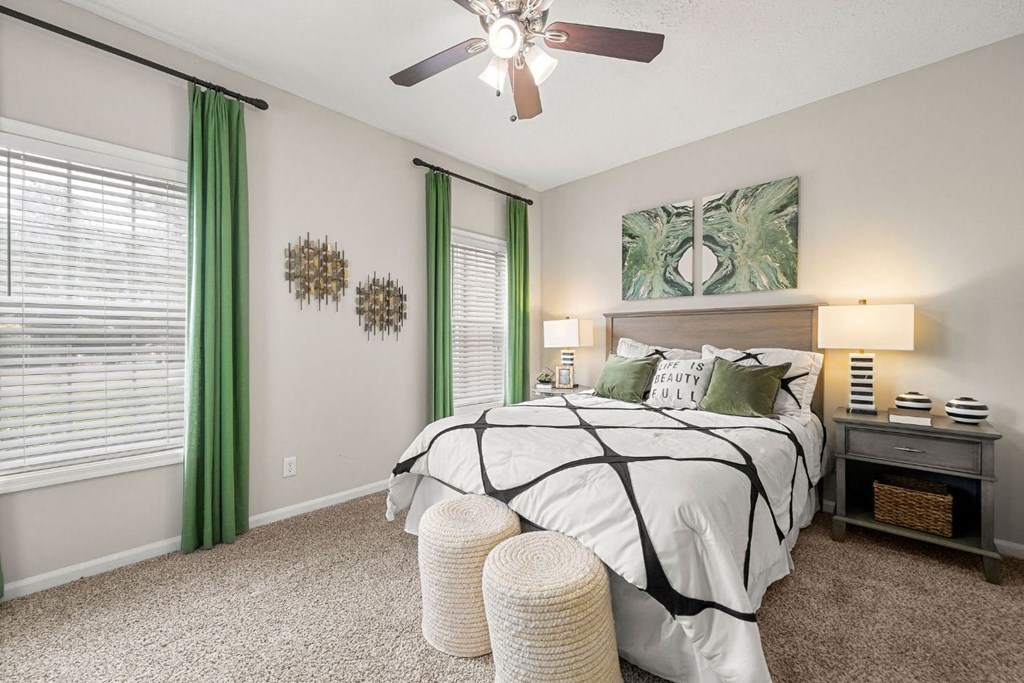 a bedroom with a bed and a ceiling fan