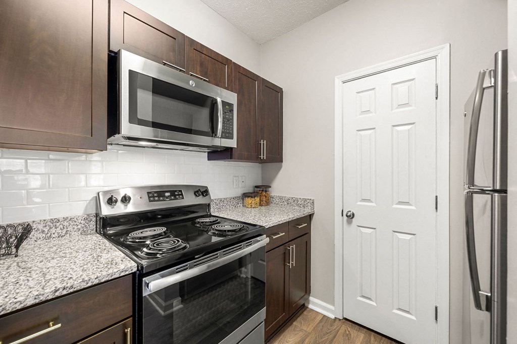 a kitchen with stainless steel appliances and granite counter tops