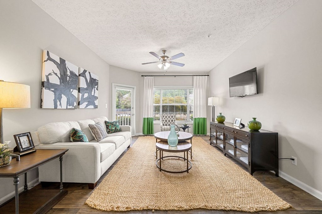a living room with a couch and a ceiling fan