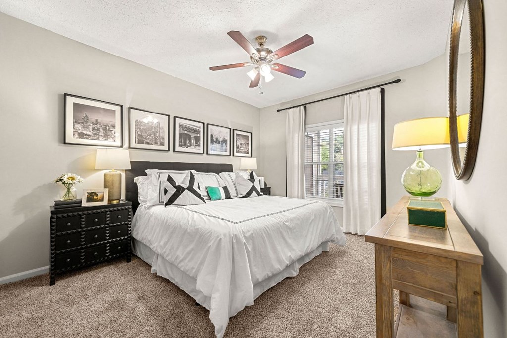 a bedroom with a bed and a ceiling fan