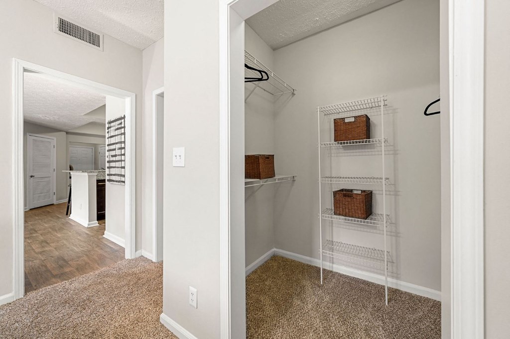 a spacious closet with shelves in a renovated home