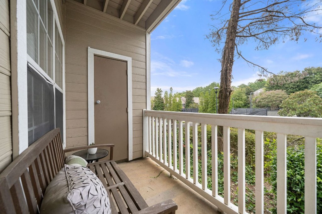 the view from the deck of a home with a door to the yard