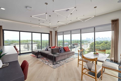 A modern living room with a grey sofa and a wooden table.