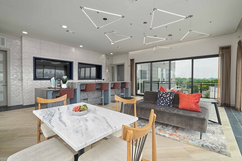 A modern dining room with a marble table and chairs.