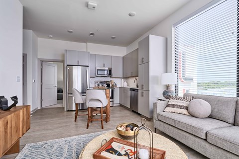 A modern kitchen with a dining table and chairs.