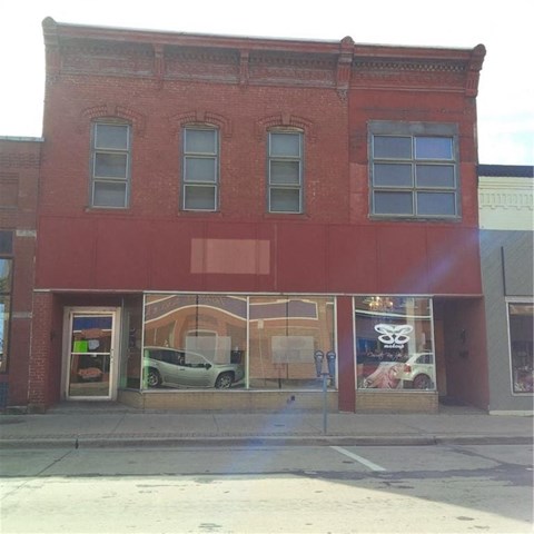 a red building with a car in the window