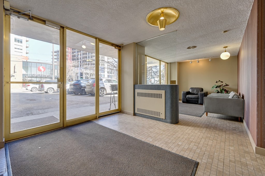 a lobby with large glass doors and a reception desk