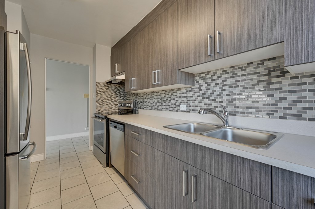 a kitchen with a sink and a refrigerator