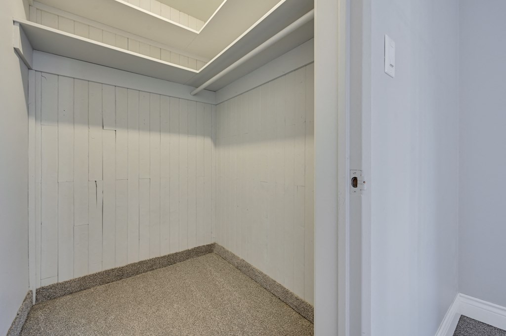 an empty room with white walls and a white door
